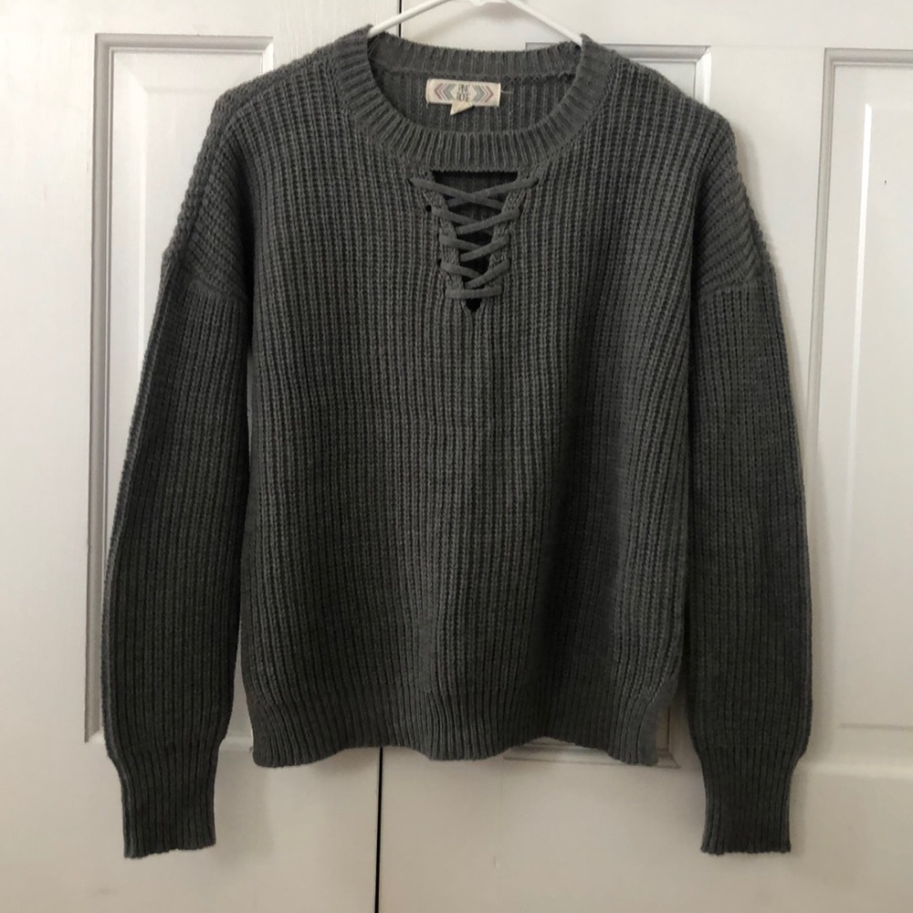 A long sleeve dark gray sweater